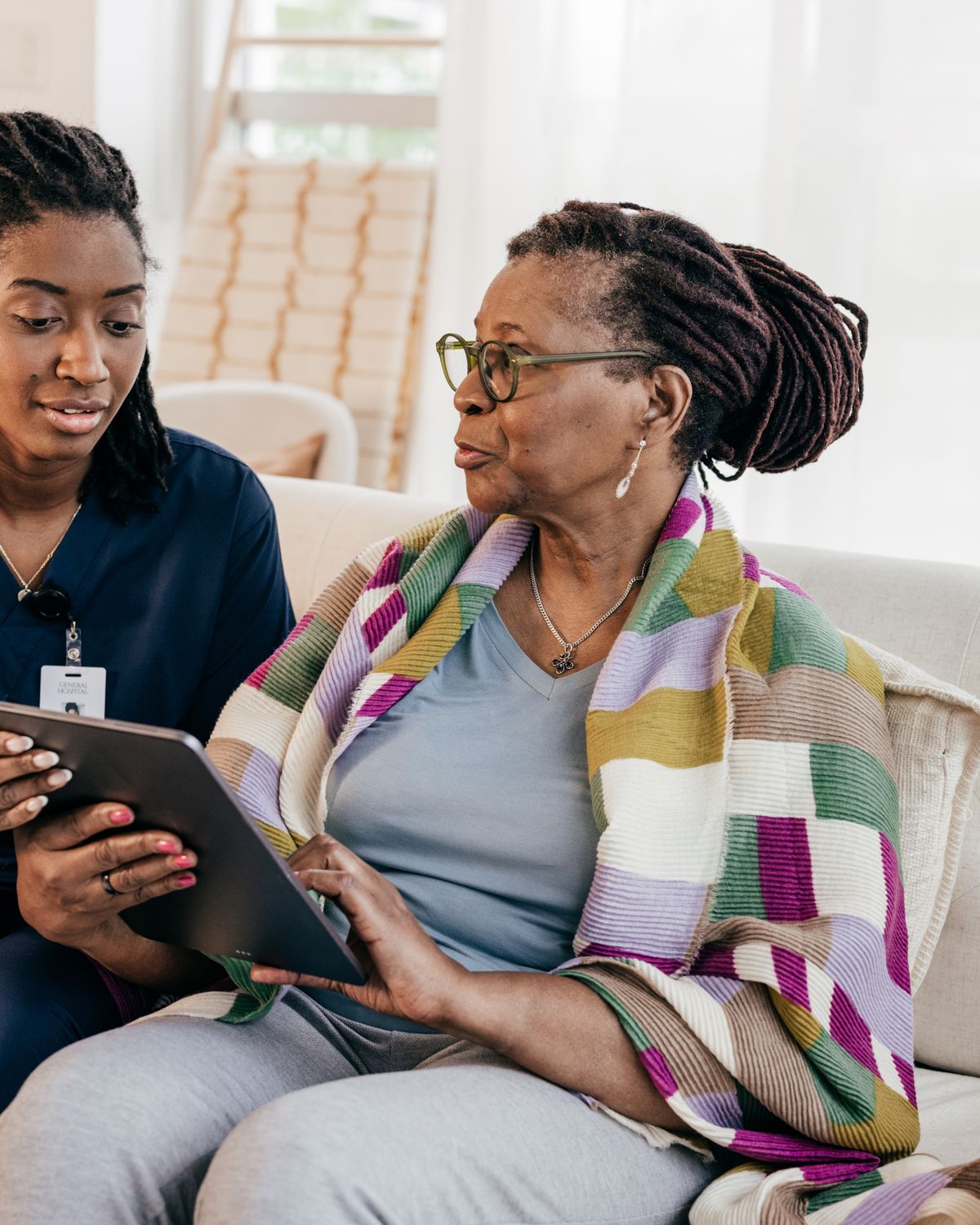 A caregiver sharing a warm embrace with an elderly client at home